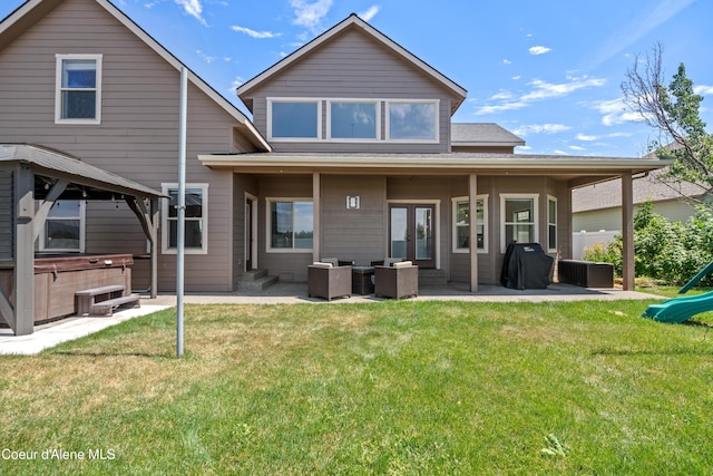 9433 N Justice Way, Hayden, ID 83835 - back of house with a hot tub, a patio, a lawn, and a gazebo