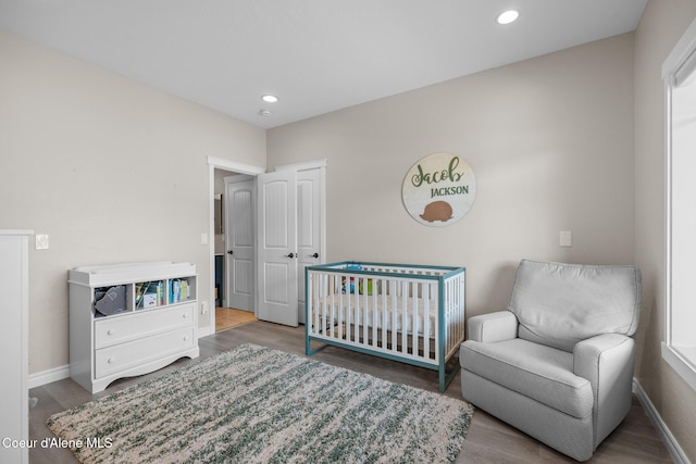 9433 N Justice Way, Hayden, ID 83835 - bedroom with wood finished floors, recessed lighting, and a nursery area