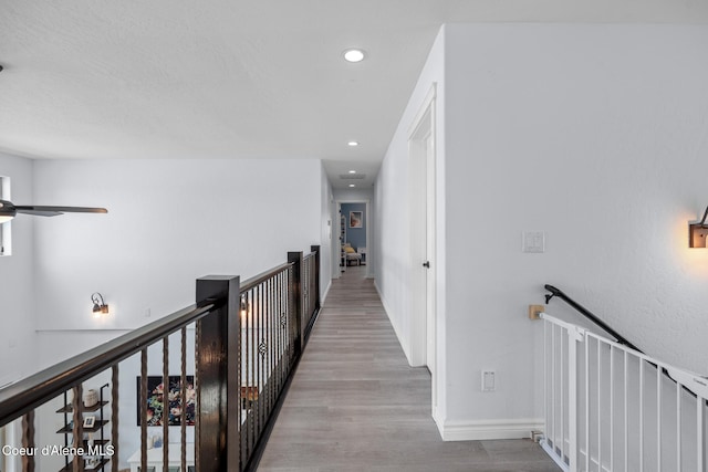 9433 N Justice Way, Hayden, ID 83835 - hallway featuring wood finished floors, recessed lighting, and an upstairs landing
