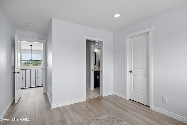 9433 N Justice Way, Hayden, ID 83835 - unfurnished bedroom featuring light wood-style floors, recessed lighting, and ensuite bathroom
