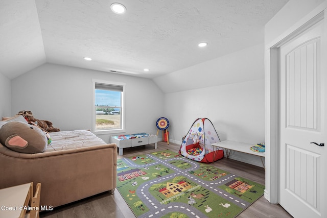 9433 N Justice Way, Hayden, ID 83835 - playroom with lofted ceiling, wood finished floors, recessed lighting, and a textured ceiling