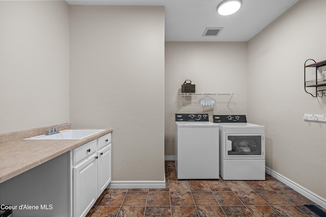 9433 N Justice Way, Hayden, ID 83835 - laundry room featuring separate washer and dryer, cabinet space, and dark stone finish flooring