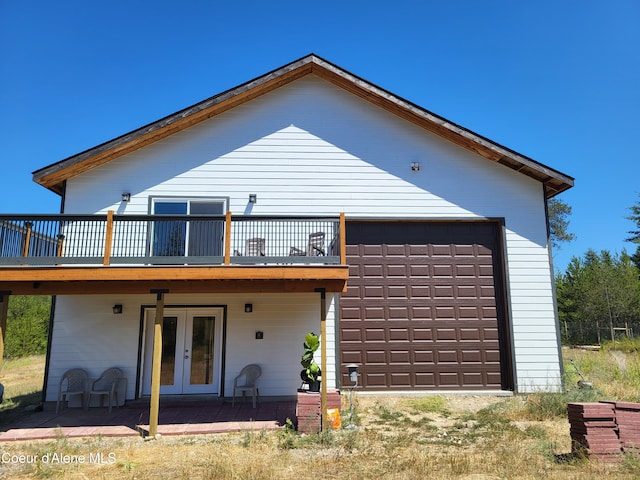 29222 N 1st St, Athol, ID 83801 - back of property with french doors, a garage, and a deck