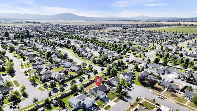 13388 N Polaris St, Rathdrum, ID 83858 - aerial view of property and surrounding area featuring a mountainous background and nearby suburban area