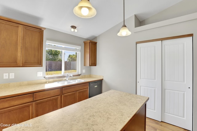 13388 N Polaris St, Rathdrum, ID 83858 - kitchen with black dishwasher, brown cabinetry, lofted ceiling, and light countertops
