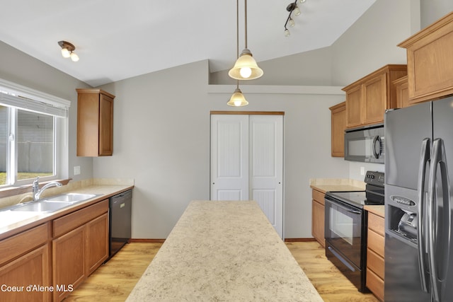 13388 N Polaris St, Rathdrum, ID 83858 - kitchen with black appliances, lofted ceiling, light wood-style floors, light countertops, and decorative light fixtures