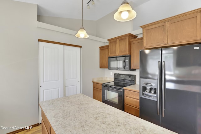 13388 N Polaris St, Rathdrum, ID 83858 - kitchen with black appliances, light countertops, brown cabinetry, pendant lighting, and high vaulted ceiling