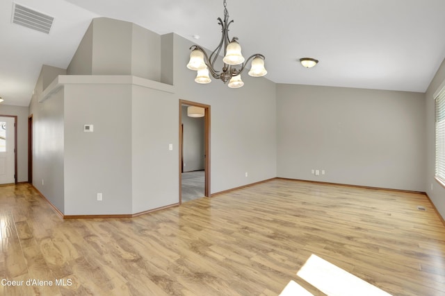 13388 N Polaris St, Rathdrum, ID 83858 - unfurnished room featuring a chandelier, light wood finished floors, and high vaulted ceiling