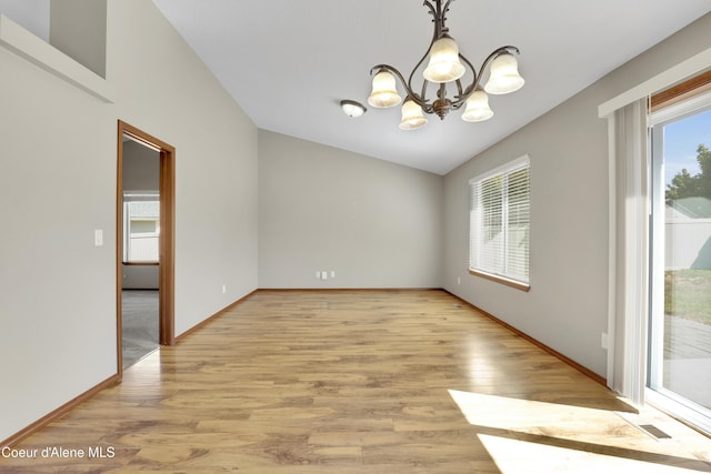 13388 N Polaris St, Rathdrum, ID 83858 - unfurnished room featuring a chandelier, light wood finished floors, and vaulted ceiling