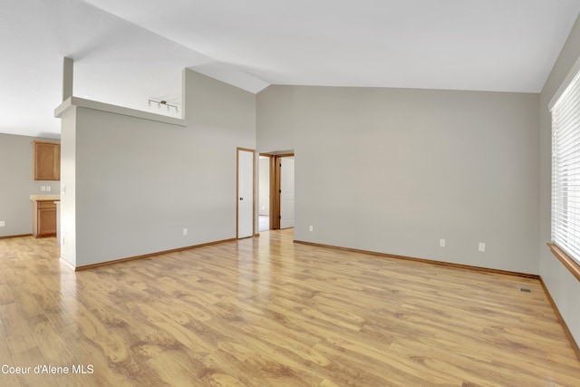 13388 N Polaris St, Rathdrum, ID 83858 - spare room featuring light wood finished floors and high vaulted ceiling