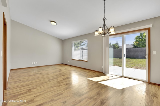 13388 N Polaris St, Rathdrum, ID 83858 - spare room with a chandelier and light wood-style floors