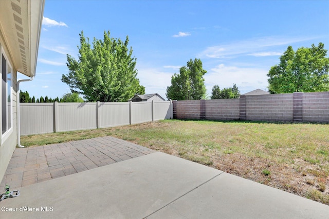 13388 N Polaris St, Rathdrum, ID 83858 - fenced backyard featuring a patio