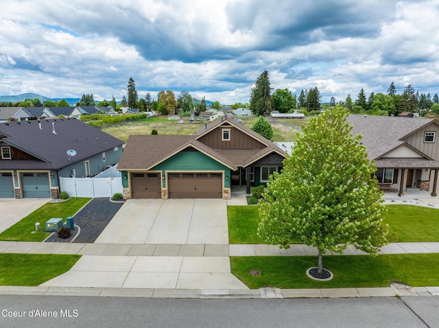 10939 N Seaside St, Hayden, ID 83835 - craftsman house with a garage, board and batten siding, stone siding, and concrete driveway