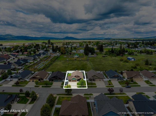 10939 N Seaside St, Hayden, ID 83835 - aerial view of residential area featuring property boundaries highlighted and a mountainous background