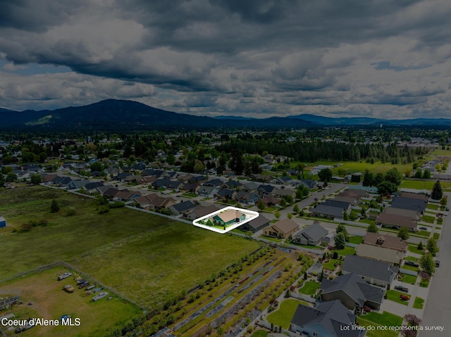 10939 N Seaside St, Hayden, ID 83835 - aerial perspective of suburban area with property parcel outlined and a mountain backdrop