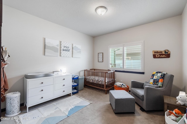 10939 N Seaside St, Hayden, ID 83835 - bedroom with light colored carpet and a nursery area