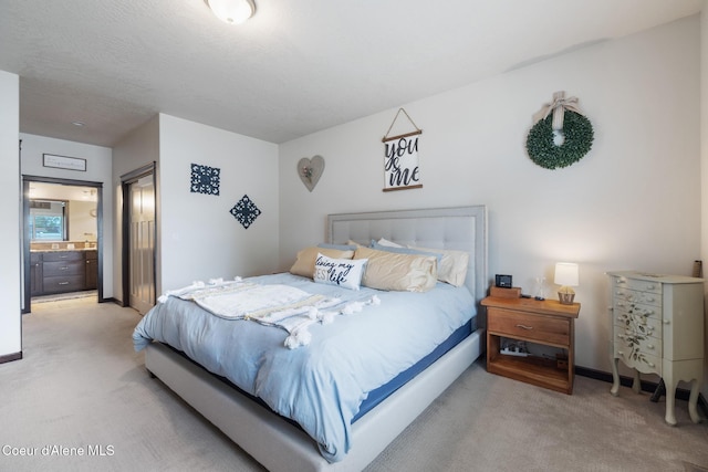10939 N Seaside St, Hayden, ID 83835 - bedroom with light carpet and connected bathroom