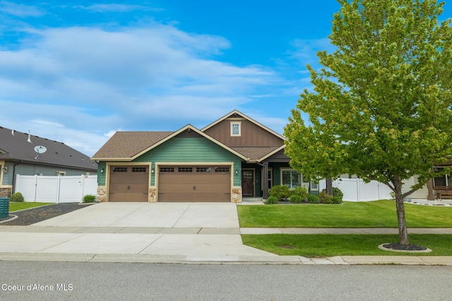 10939 N Seaside St, Hayden, ID 83835 - craftsman house featuring an attached garage, stone siding, concrete driveway, and board and batten siding
