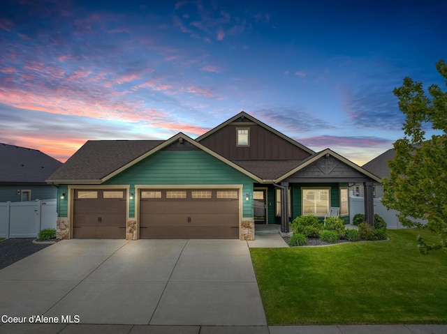 10939 N Seaside St, Hayden, ID 83835 - view of front of house featuring an attached garage, board and batten siding, concrete driveway, and stone siding