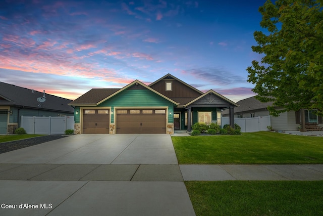 10939 N Seaside St, Hayden, ID 83835 - craftsman house featuring an attached garage, driveway, stone siding, and board and batten siding
