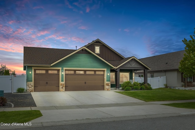 10939 N Seaside St, Hayden, ID 83835 - craftsman-style home with board and batten siding, stone siding, an attached garage, driveway, and a gate