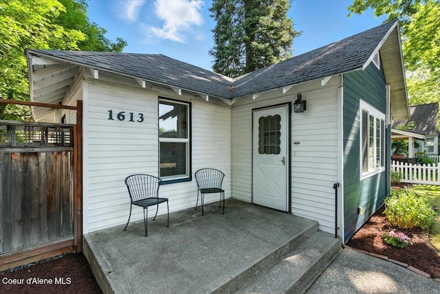 1613 E Coeur D Alene Ave, Coeur Dalene, ID 83814 - rear view of property with a shingled roof