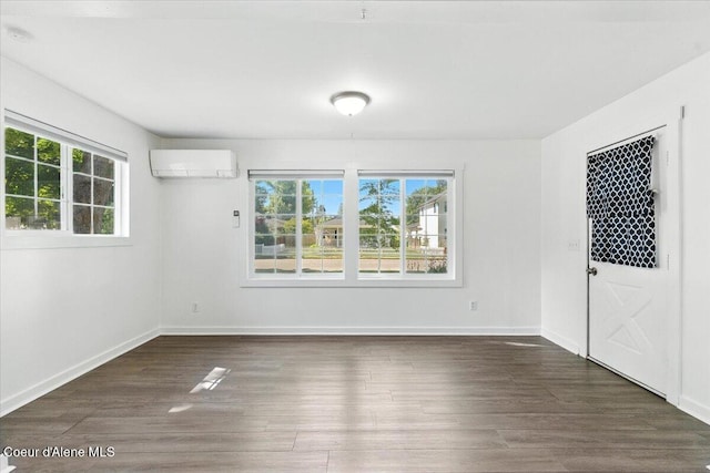 1613 E Coeur D Alene Ave, Coeur Dalene, ID 83814 - spare room featuring a wall mounted AC, plenty of natural light, and wood finished floors