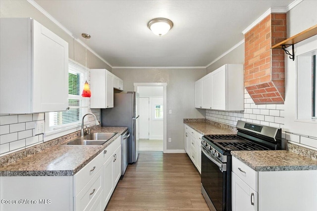 1613 E Coeur D Alene Ave, Coeur Dalene, ID 83814 - kitchen featuring stainless steel appliances, plenty of natural light, ornamental molding, and white cabinets