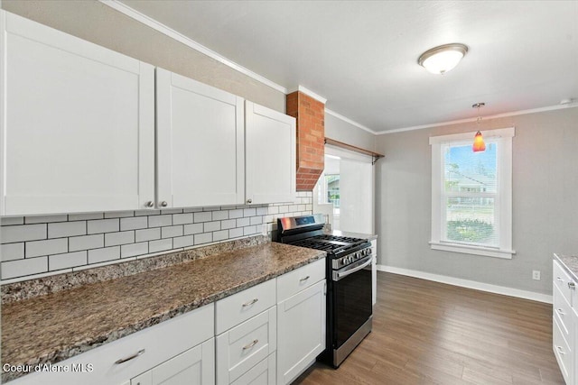 1613 E Coeur D Alene Ave, Coeur Dalene, ID 83814 - kitchen with stainless steel range with gas stovetop, tasteful backsplash, ornamental molding, white cabinets, and light wood-style floors