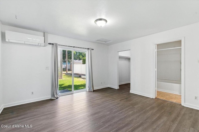 1613 E Coeur D Alene Ave, Coeur Dalene, ID 83814 - unfurnished bedroom with a wall mounted air conditioner, wood finished floors, access to outside, and ensuite bathroom