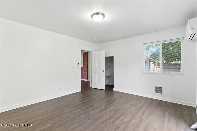 1613 E Coeur D Alene Ave, Coeur Dalene, ID 83814 - spare room with dark wood-style floors and a wall mounted AC