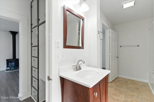 1613 E Coeur D Alene Ave, Coeur Dalene, ID 83814 - bathroom featuring vanity and a wood stove