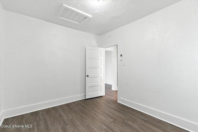 1613 E Coeur D Alene Ave, Coeur Dalene, ID 83814 - unfurnished room featuring attic access and dark wood finished floors