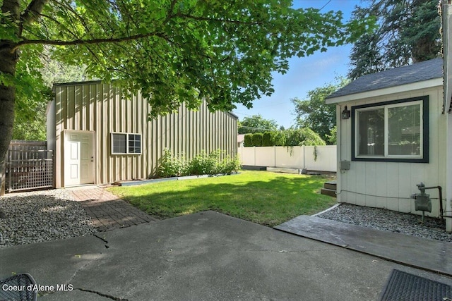 1613 E Coeur D Alene Ave, Coeur Dalene, ID 83814 - fenced backyard with a patio and an outbuilding
