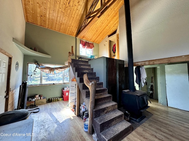 1484 W Elkhorn Meadows Rd, Fernwood, ID 83830 - stairway featuring a wood stove, wood finished floors, high vaulted ceiling, and a wooden ceiling with exposed beams