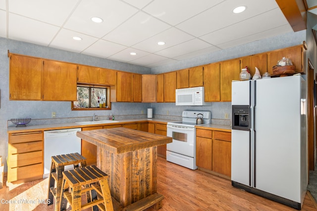 5341 Hoo Doo Loop, Oldtown, ID 83822 - kitchen with white appliances, light wood-style floors, brown cabinets, a drop ceiling, and recessed lighting