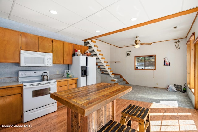5341 Hoo Doo Loop, Oldtown, ID 83822 - kitchen with white appliances, brown cabinetry, ceiling fan, light countertops, and light wood-style floors