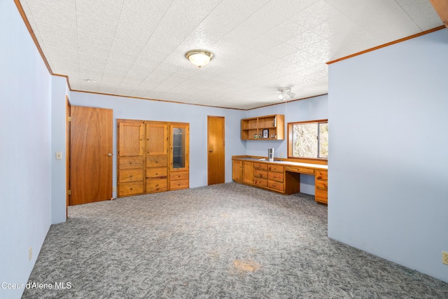 5341 Hoo Doo Loop, Oldtown, ID 83822 - unfurnished bedroom with carpet, built in desk, and ornamental molding