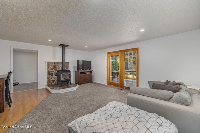 1814 E Jenny Lynn Ln, Coeur Dalene, ID 83815 - bedroom with a wood stove, a textured ceiling, recessed lighting, and carpet