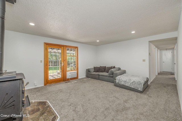 1814 E Jenny Lynn Ln, Coeur Dalene, ID 83815 - living room with a wood stove, carpet floors, recessed lighting, and a textured ceiling