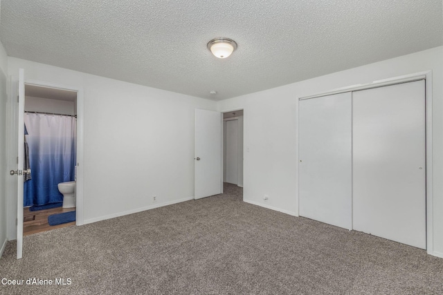 1814 E Jenny Lynn Ln, Coeur Dalene, ID 83815 - unfurnished bedroom featuring carpet flooring, a closet, connected bathroom, and a textured ceiling