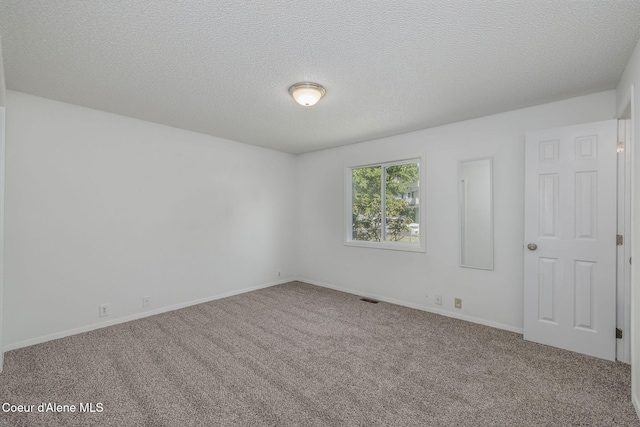 1814 E Jenny Lynn Ln, Coeur Dalene, ID 83815 - carpeted spare room with baseboards and a textured ceiling