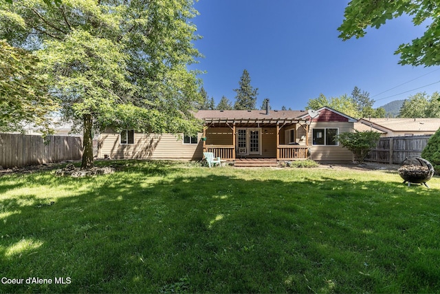 1814 E Jenny Lynn Ln, Coeur Dalene, ID 83815 - rear view of house with a fenced backyard, an outdoor fire pit, a deck, and a pergola