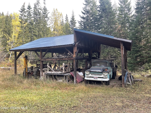 1728 Dry Creek Rd, Clark Fork, ID 83811 - view of parking / parking lot featuring a wooded view and a detached carport