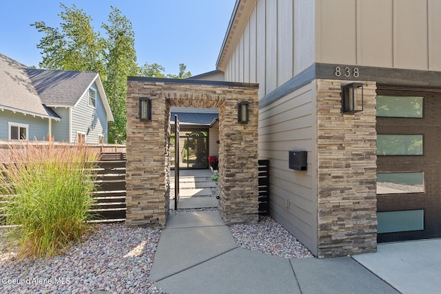 838 N Government Way, Coeur Dalene, ID 83814 - view of exterior entry featuring board and batten siding and stone siding