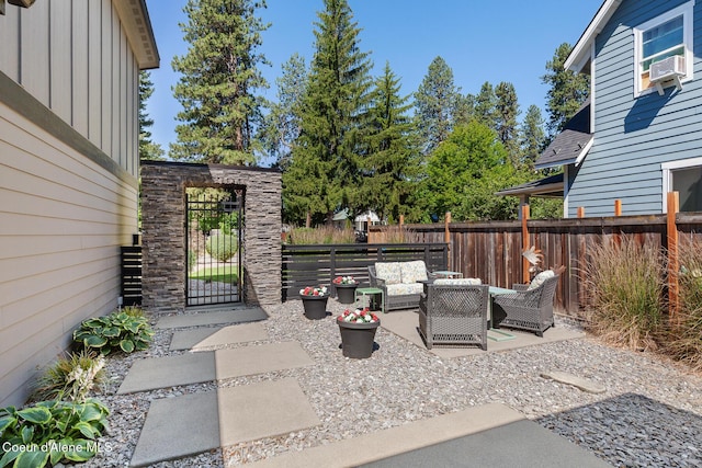838 N Government Way, Coeur Dalene, ID 83814 - view of patio featuring an outdoor hangout area, a gate, and cooling unit
