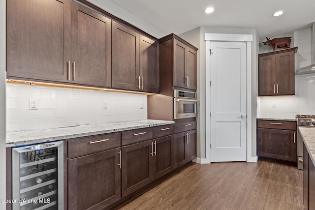 838 N Government Way, Coeur Dalene, ID 83814 - kitchen featuring beverage cooler, dark wood-style flooring, appliances with stainless steel finishes, dark brown cabinetry, and recessed lighting