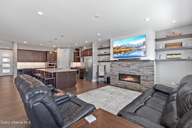 838 N Government Way, Coeur Dalene, ID 83814 - living room with dark wood-style flooring, a stone fireplace, and recessed lighting