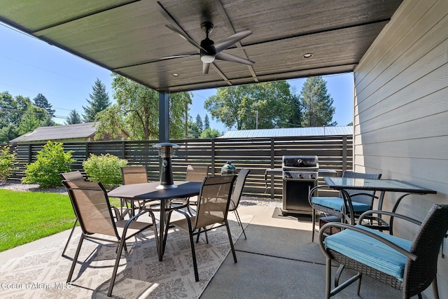 838 N Government Way, Coeur Dalene, ID 83814 - fenced backyard with outdoor dining area, grilling area, a patio area, and ceiling fan