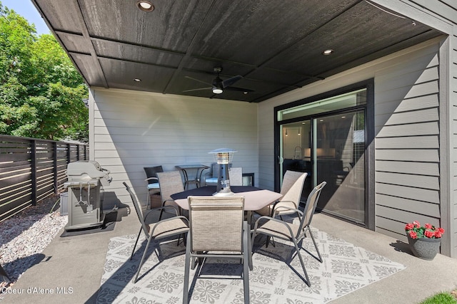 838 N Government Way, Coeur Dalene, ID 83814 - fenced backyard with area for grilling, a patio area, outdoor dining area, and a ceiling fan